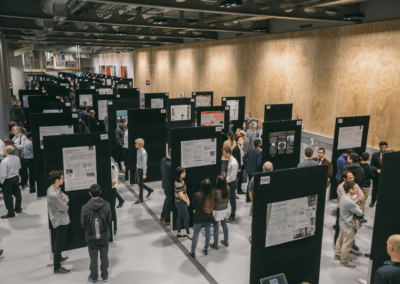 AUT Poster Showcase, shows a large number of posters and people looking at them